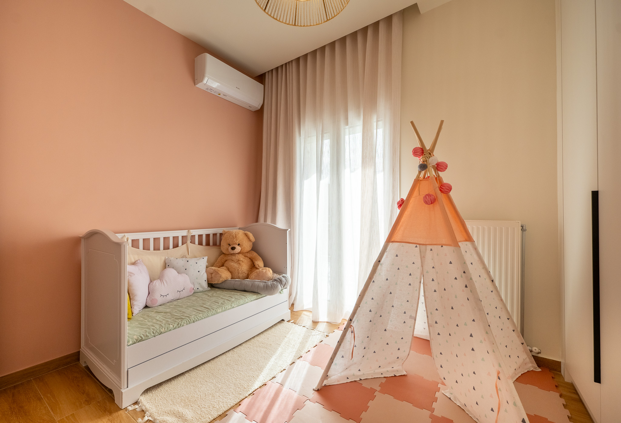 A&K Chorothetisis, kids' room with peach accent wall and printed teepee
