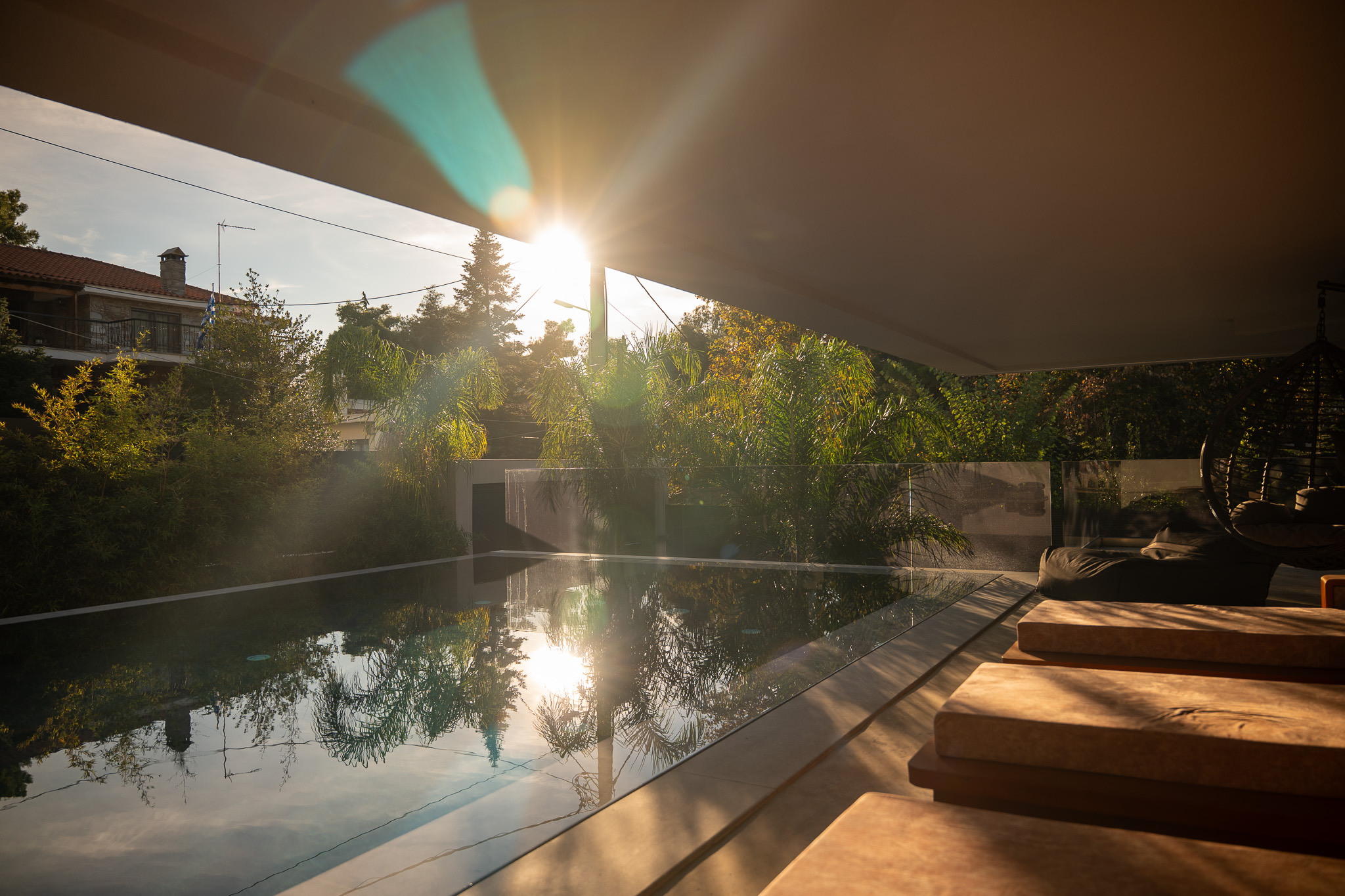 Villa Bond, golden sun-burst over mirror-still pool