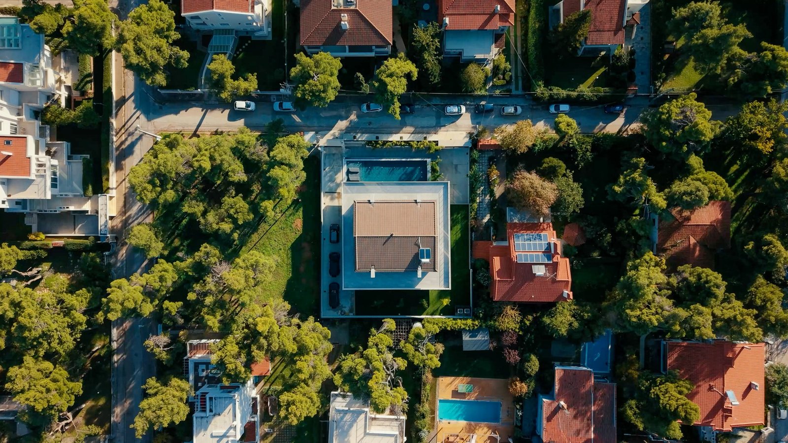 Villa Bond, top-down aerial of villa centred among pines and lawn