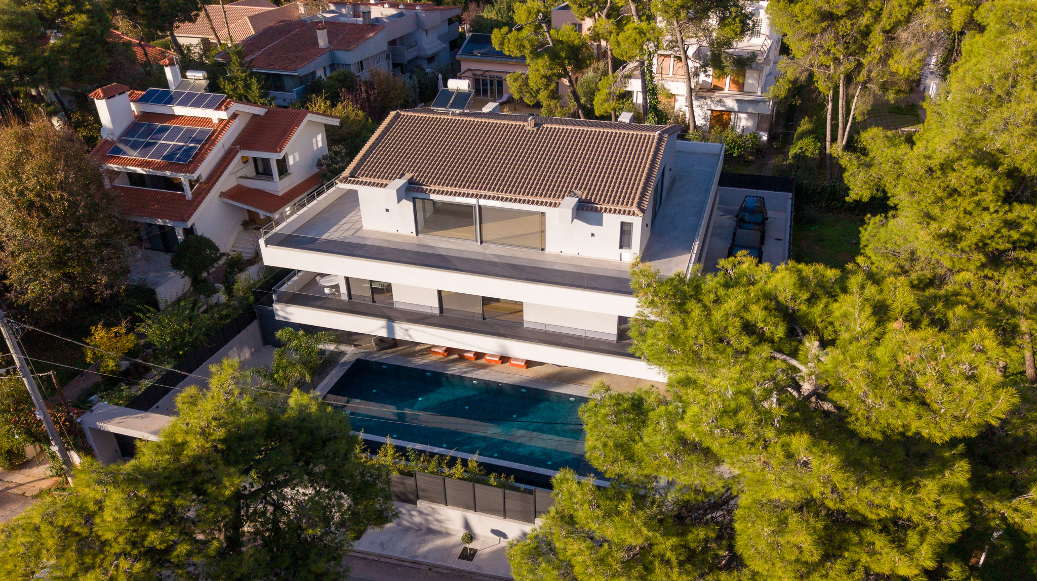 Villa Bond, top-down birds-eye over the full plot, dense greenery around the villa